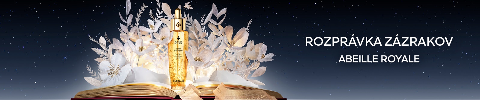 Luxusné pleťové sérum Guerlain Abeille Royale s medom a zlatými mikročasticami na pozadí kvetov – kolekcia Rozprávka zázrakov.